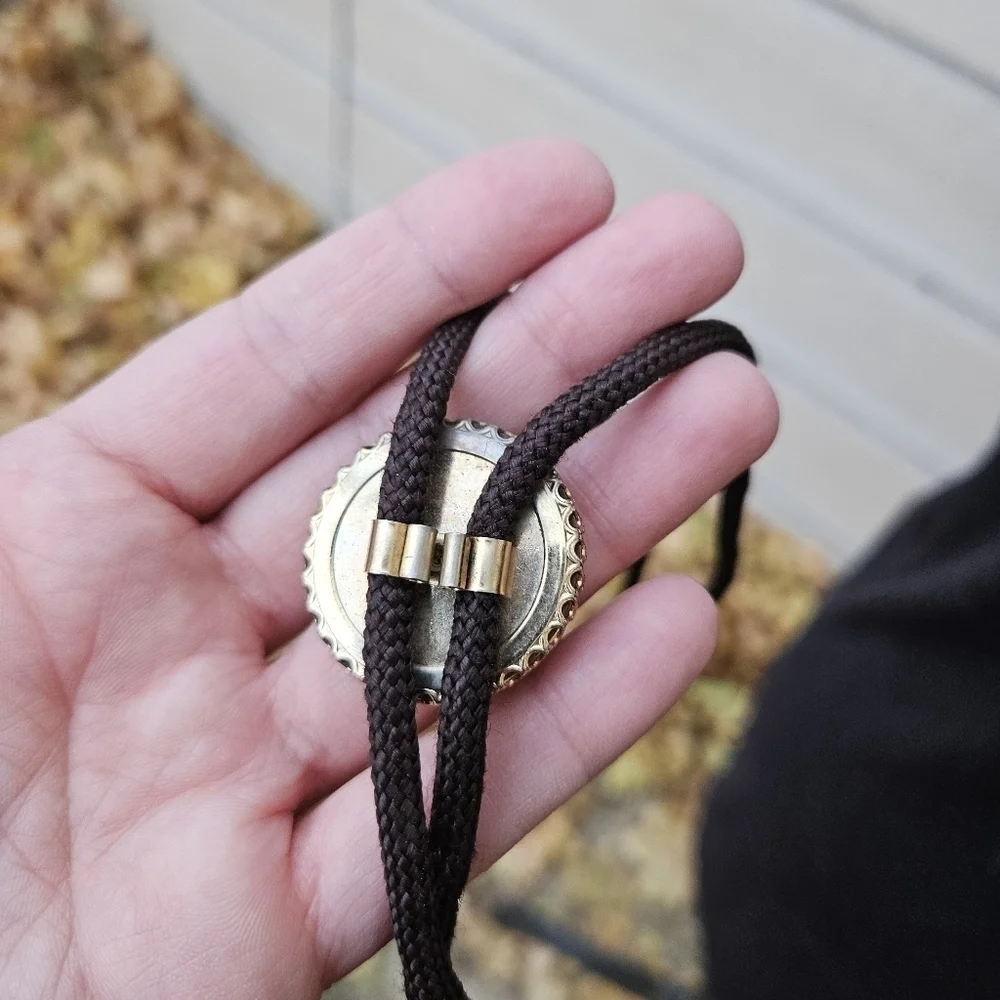 gold leaf and goldstone bolo tie on brown cord